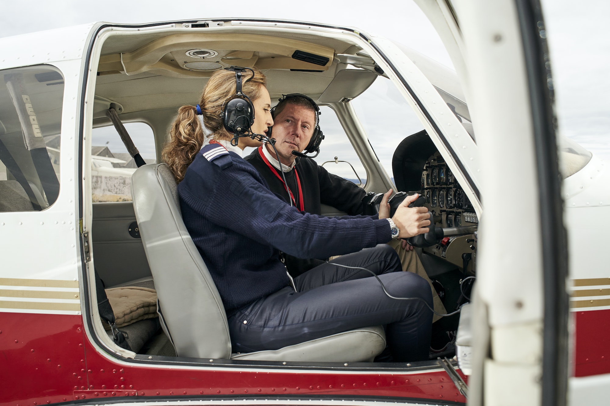 Pilot in training and flight instructor in the cockpit of an airplane.